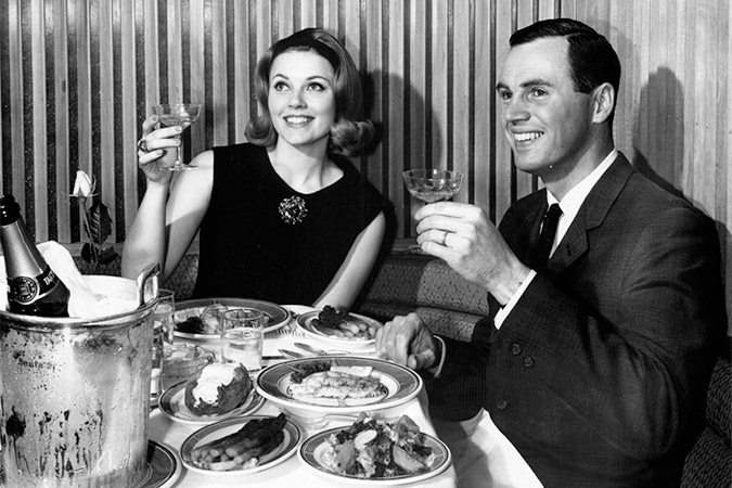 A couple enjoys dinner served on Santa Fe’s Mimbreño china