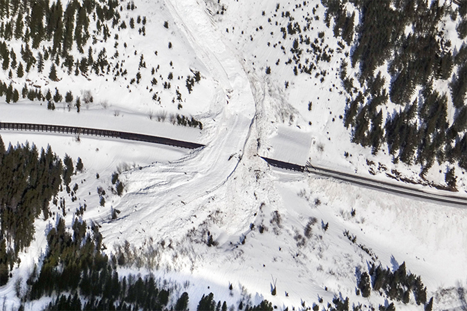 The path of this area’s avalanches can be seen in the center. Underneath this path is a snow shed that is strategically placed to divert the snow over the tracks.